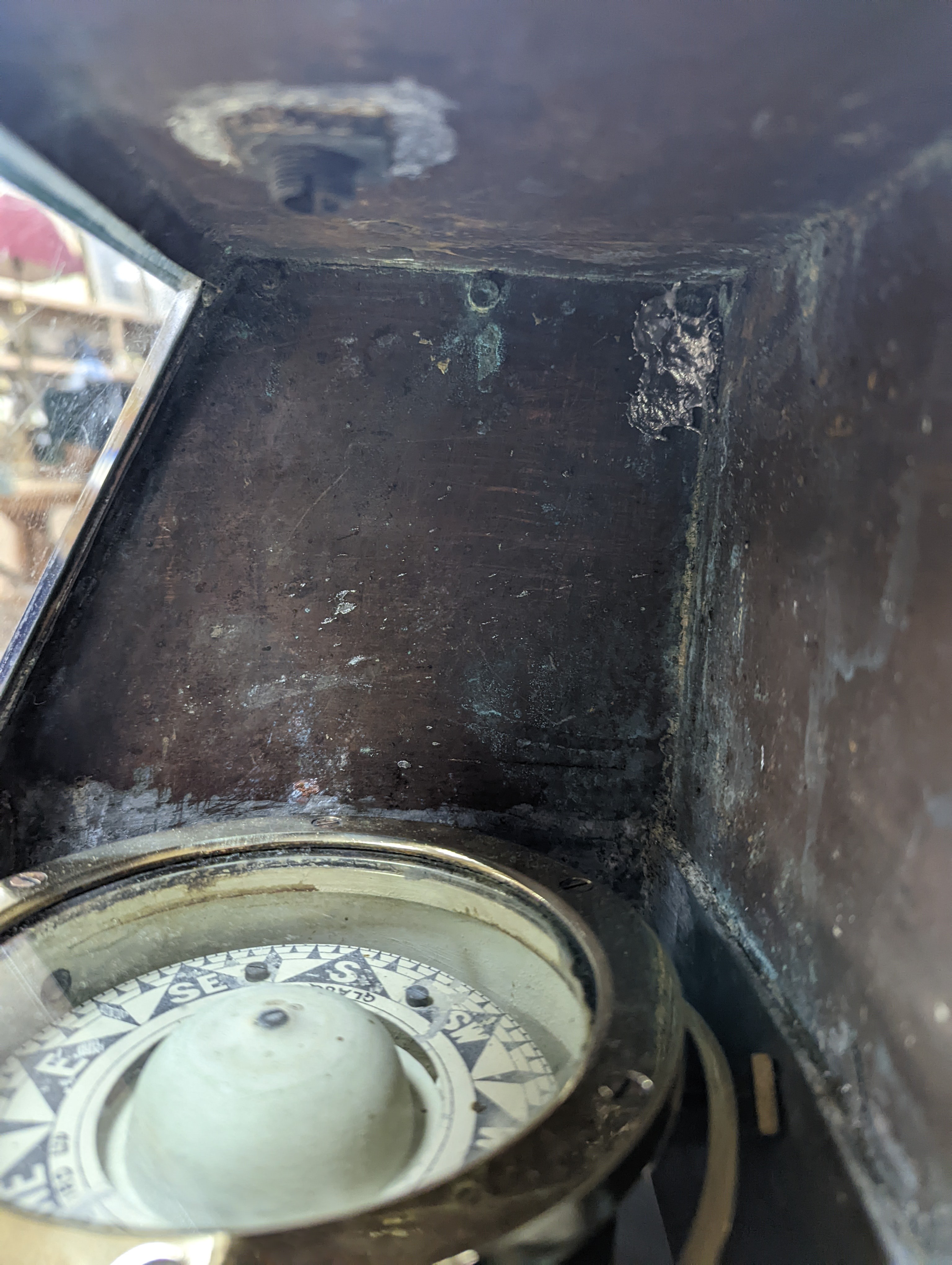 A copper ship's binnacle compass, a brass oil lamp, a brass jug and a copper kettle